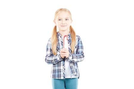 Portrait of beautiful little girl in checked shirt against white backgroundの写真素材