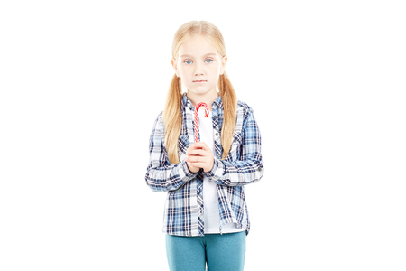 Portrait of beautiful little girl in checked shirt against white backgroundの写真素材