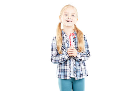 Portrait of beautiful little girl in checked shirt against white backgroundの写真素材