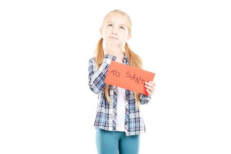 Portrait of little girl holding envelope with letter to Santaの写真素材