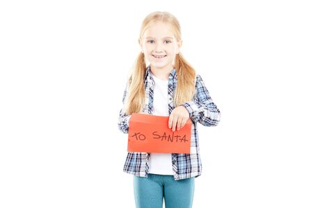 Portrait of little girl holding envelope with letter to Santaの写真素材
