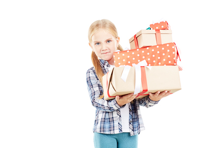 Studio portrait of little girl holding stack of Christmas giftsの写真素材