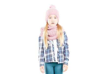 Studio portrait of little girl wearing knit hat and snood scarfの写真素材