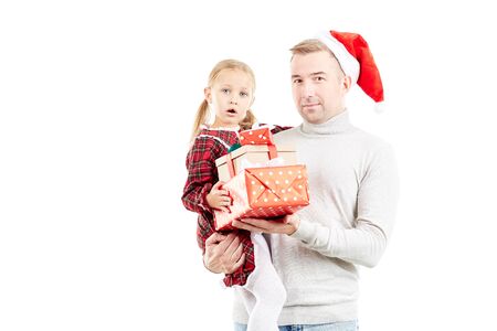 Portrait of man in Santa hat holding little daughter and Christmas giftsの写真素材