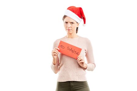 Portrait of woman in Santa hat holding envelope with letter to Santaの写真素材
