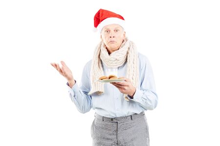 Portrait of senior man in Santa hat on white backgroundの写真素材