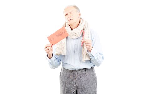Portrait of senior man holding envelope with letter to Santaの写真素材