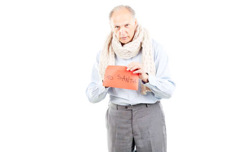 Portrait of senior man holding envelope with letter to Santaの写真素材