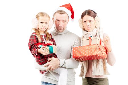 Christmas portrait of family consisting of mother, father and daughter on white backgroundの写真素材