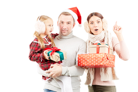 Christmas portrait of family consisting of mother, father and daughter on white backgroundの写真素材
