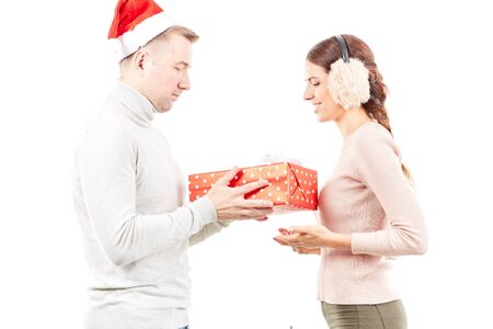 Studio portrait of man and woman with Christmas present on white backgroundの写真素材