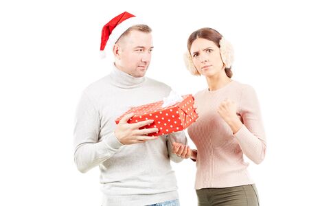 Studio portrait of man and woman with Christmas present on white backgroundの写真素材