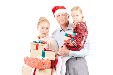 Christmas portrait of grandparents and granddaughter posing with giftsの写真素材