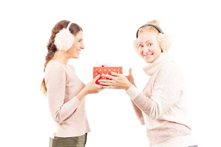 Portrait of senior mother and adult daughter exchanging Christmas giftsの写真素材