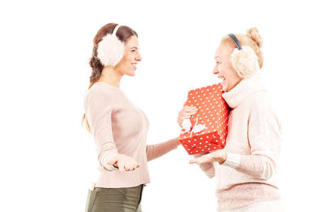 Portrait of senior mother and adult daughter exchanging Christmas giftsの写真素材