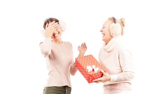 Portrait of senior mother and adult daughter exchanging Christmas giftsの写真素材