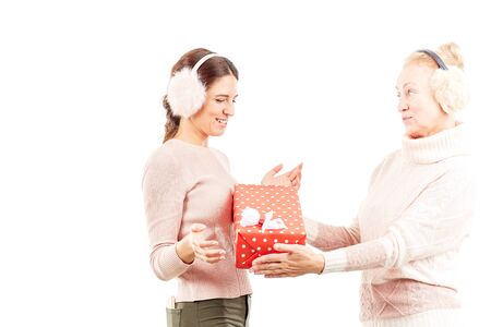 Portrait of senior mother and adult daughter exchanging Christmas giftsの写真素材