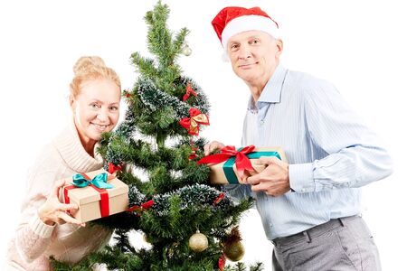 Portrait of senior couple posing near Christmas treeの写真素材