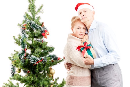 Portrait of senior couple posing near Christmas treeの写真素材