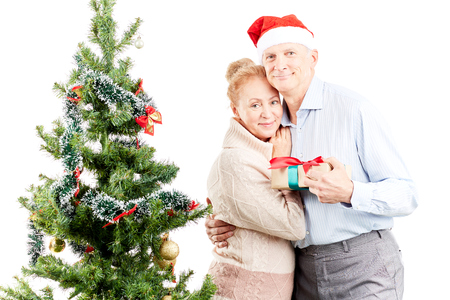 Portrait of senior couple posing near Christmas treeの写真素材