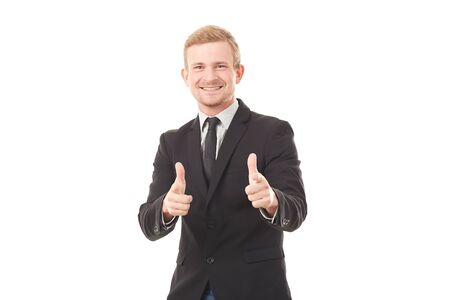Portrait of young businessman in black suit pointing at you on white backgroundの写真素材