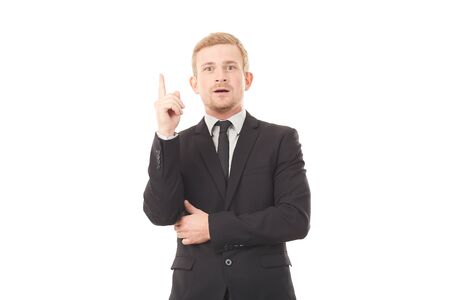 Portrait of young creative businessman in black suit on white backgroundの写真素材
