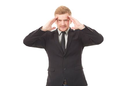 Portrait of stressed businessman in black suit on white backgroundの写真素材