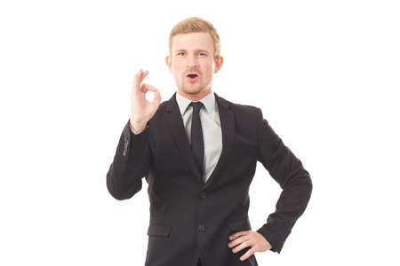 Portrait of young businessman in black suit on white backgroundの写真素材