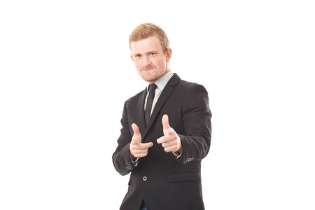Portrait of young businessman in black suit pointing at you on white backgroundの写真素材