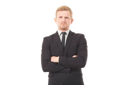 Portrait of displeased businessman in black suit on white backgroundの写真素材