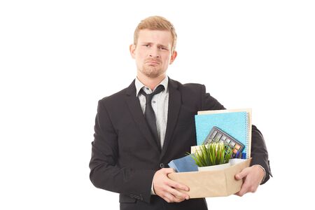 Portrait of young man holding box with personal belongings on white backgroundの写真素材
