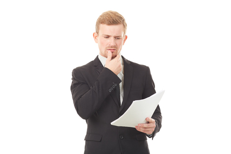 Portrait of young manager in black suit holding document on white backgroundの写真素材