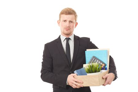 Portrait of young man holding box with personal belongings on white backgroundの写真素材