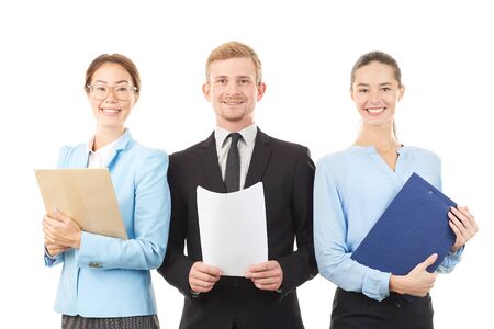 Portrait of young business team consisting of two women and man on white backgroundの写真素材