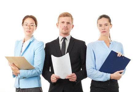 Portrait of young business team consisting of two women and man on white backgroundの写真素材