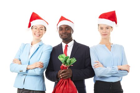 Portrait of three multi-ethnic office workers celebrating Christmasの写真素材
