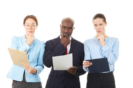 Portrait of confident multi-ethnic business team of three on white backgroundの写真素材