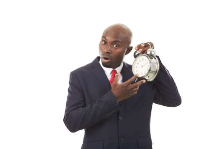Portrait of young African manager holding alarm clockの写真素材