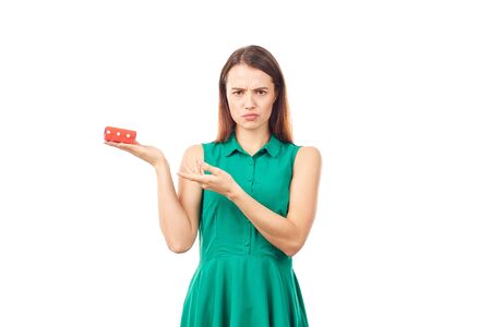 Studio portrait of beautiful young woman holding small gift box on white backgroundの写真素材
