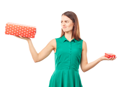 Portrait of young woman holding big gift box in one hand and small in anotherの写真素材