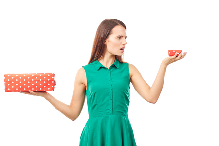 Portrait of young woman holding big gift box in one hand and small in anotherの写真素材
