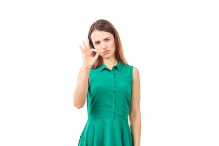 Portrait of emotional young woman in emerald green dress on white backgroundの写真素材