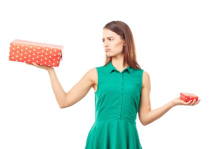 Portrait of young woman holding big gift box in one hand and small in anotherの写真素材