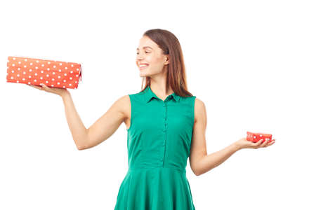 Portrait of young woman holding big gift box in one hand and small in anotherの写真素材