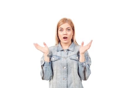 Portrait of emotional blonde woman wearing denim jacket on white backgroundの写真素材