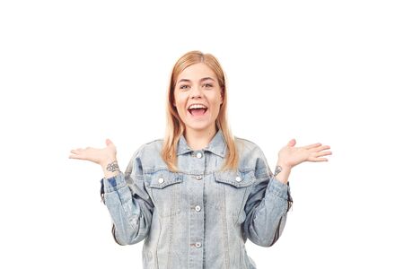 Portrait of emotional blonde woman wearing denim jacket on white backgroundの写真素材