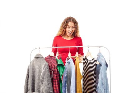 Young woman browsing through clothes on rackの写真素材