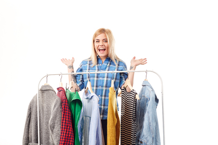 Young woman browsing through clothes on rackの写真素材