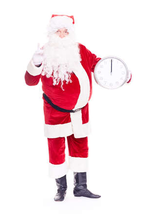 Portrait of Santa Claus in traditional costume holding clocks showing midnightの写真素材