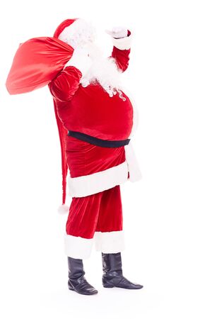 Portrait of Christmas character Santa Claus in traditional costume with red sack on white backgroundの写真素材